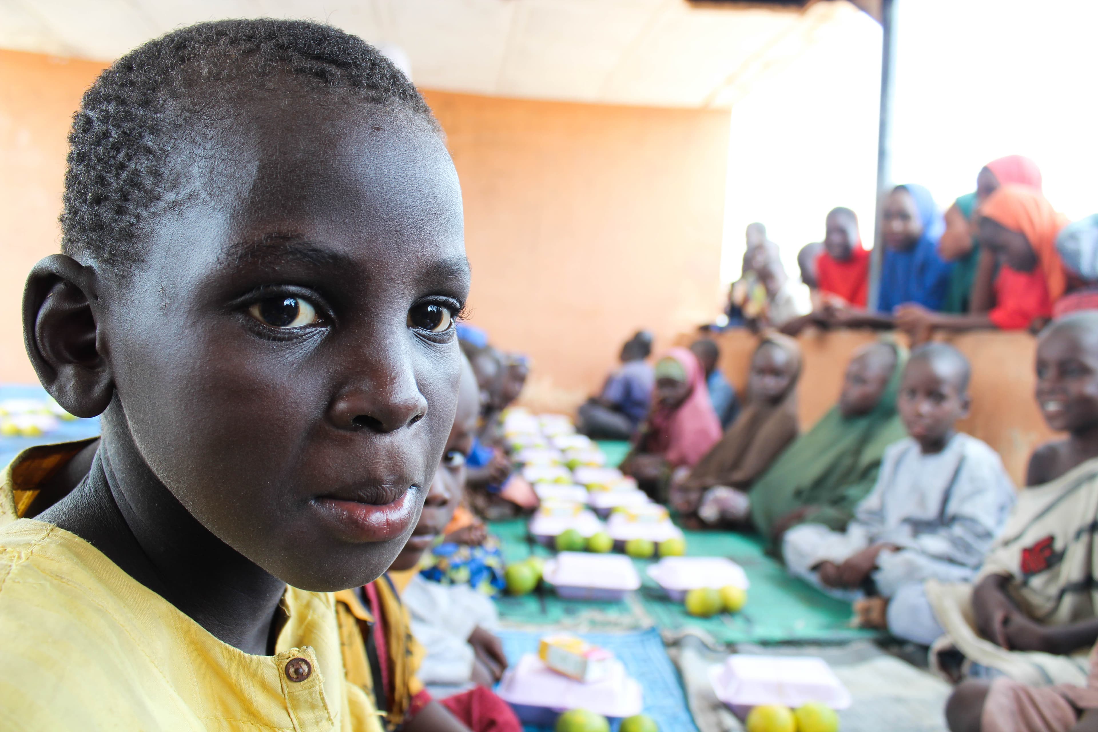 A child stares at the camera in an IDP camp in Maiduguri